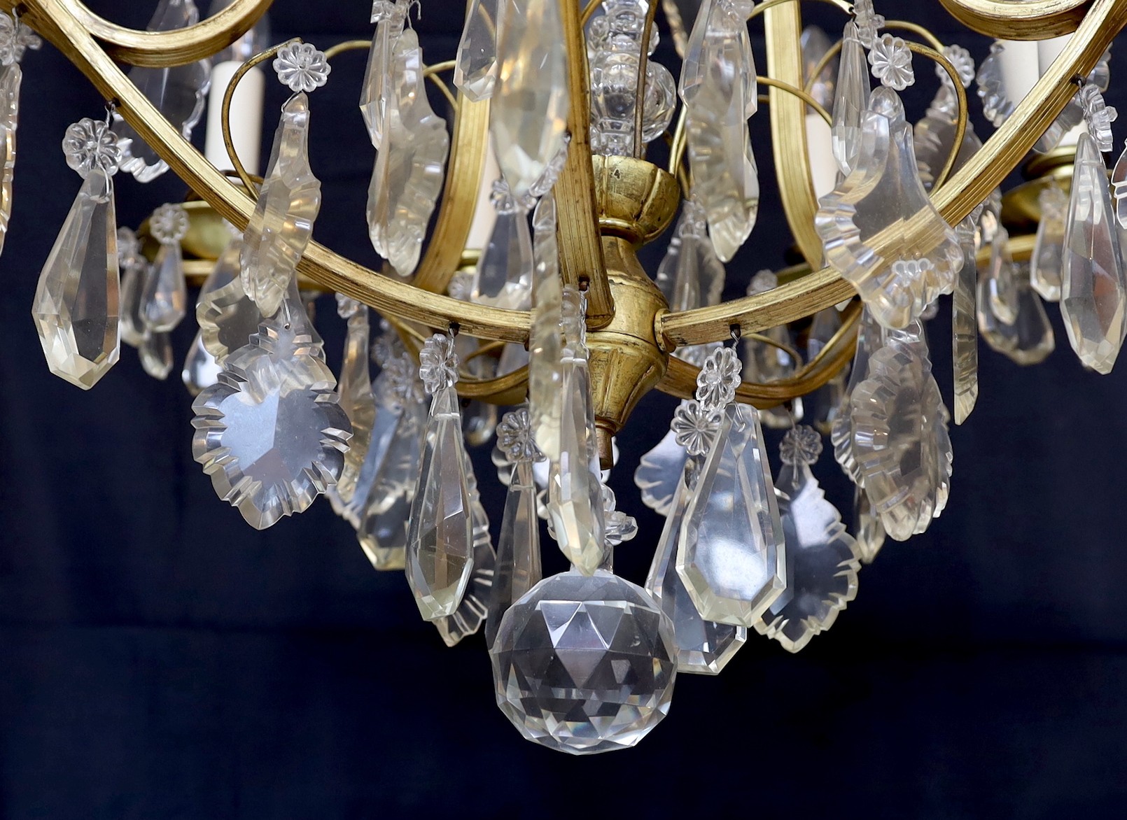 An early 20th century French silver and bronze and cut glass ten light chandelier hung with lozenge and tear shaped drops, drop 82cm. width 60cm